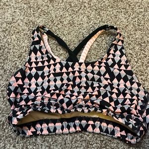 Strappy back design, supportive, gray, pink. Black triangles.